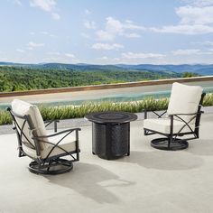 two chairs and a table sitting on top of a patio