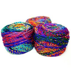 three skeins of multicolored twine on white background