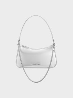 This simple bag is instantly transformed into a statement piece, thanks to its striking metallic silver finish. The classic silhouette is complete with subtle rounded corners and a minimalist design that makes this a piece that will transcend seasons and trends. It comes with silver-toned hardware for a complementary silver-on-silver colourway. With ample space to hold your most-used essentials, this little bag is the perfect party companion. Prom Bag, Simple Bag, Silver Bag, Silver Bags, Metallic Purse, Metallic Bag, Size Chart For Kids, Charles Keith, Simple Bags