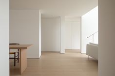 an empty room with white walls and wooden floors