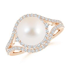 Set at the center of a split shank is a lustrous Freshwater cultured pearl, encircled with diamonds. The diamond-studded shoulders of this pearl cocktail ring form into a brilliant double halo around the stunning round pearl. This pearl and diamond double halo ring looks magnificently striking. Pearl Cocktail Ring, Cultured Pearl Ring, Split Shank Engagement Rings, Pearl Rings, Split Shank Ring, Baguette Diamond Rings, Pearl And Diamond Ring, Mabe Pearl, Double Halo