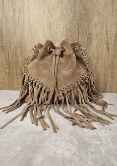 Italian Real Suede Leather Dark Beige Fringe Tassel Crossbody Bag Suede Leather Dark Beige Shoulder bag Fringe bags Beige Suede Bags Drawstring Closure Internal zipped pocket  Gold tone metal hardware  Detachable /Adjustable strap Fully lined inside  Soft Italian Real Suede Leather  Dimensions: H25cm x L25cm x D15cm Chic Brown Hobo Bag With Tassels, Beige Fringe Shoulder Bag For Daily Use, Trendy Beige Shoulder Bag With Fringe, Chic Beige Fringe Shoulder Bag, Leather Crossbody Bag With Tassels, Crossbody Bucket Bag With Tassels For Travel, Chic Bucket Shoulder Bag With Tassels, Travel Crossbody Bucket Bag With Tassels, Travel Bucket Bag With Tassels And Crossbody Shape