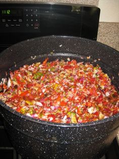 a large pan filled with food sitting on top of a stove