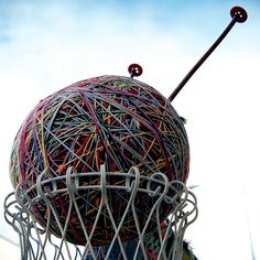 a ball of yarn is stuck in the back of a basketball net with a stick sticking out of it