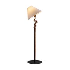 a floor lamp with a white shade on it's base and a black base