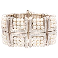 The pearl and diamond cuff bracelet of geometric design features sixteen sections each set with 9 Japanese Akoya pearls for a total of 126 lustrous pearls of 5 mm diameter. The bridges connecting these sections are set with a total of 15.20 carats of round diamonds of top quality (F/G-VVS, color, clarity and cut). The elegant bracelet is one-of-a-kind. It was entirely handmade in Italy with exquisite openwork craftsmanship and knowhow by maestro Salvatore according to an original design by Ella Vintage Pearl Bracelet, Pearl Bangles, Diamond Cuff Bracelet, Vintage Cuff Bracelet, Pearl Cuff Bracelet, Pearl Cuff, Pearl Accessories, Pearl Bracelets, Bracelets Design