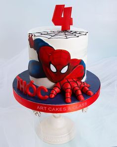 a spiderman cake with the number four on it