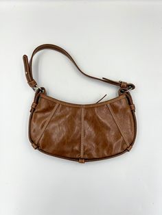 This adorable little brown man made leather bag is by Express. Perfect size if you just want the necessities. It measures approximately 5.5 (with strap 14.5) x 10.5 inches. Circa 1990s, it's a fun bag for anyone who loves vintage bags. In great vintage condition! Please keep in mind that I offer vintage and pre-owned items that may show normal signs of use including fading, small stains, scratches, chips or dings. See all photos and descriptions before purchasing. Retro Brown Satchel With Removable Pouch, Retro Brown Faux Leather Shoulder Bag, Vintage Brown Hobo Bag For Everyday, Retro Faux Leather Shoulder Bag For Everyday, Vintage Faux Leather Shoulder Bag, Vintage Faux Leather Shoulder Bag For Everyday, Vintage Everyday Faux Leather Shoulder Bag, Vintage Light Brown Bags For Everyday Use, Vintage Light Brown Bag For Everyday Use