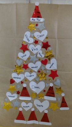 a christmas tree made out of paper with hearts and stars on the top is shown