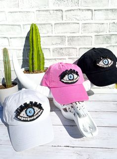 Design your own custom high ponytail hat - available in white, black and pink! 🧢This hat comes with a specially designed hole cut out towards the top of the hat in the back for your ponytail or bun!🧢 Back velcro closureEyelet holes for breathabilityOne size fits most (adjustable) Trendy Adjustable Cap Costume Headpieces, Trendy Adjustable Cap Costume Hat, Trendy Adjustable Costume Hat With Curved Brim, Fun White Brimmed Baseball Cap, Fun White Costume Hats And Headpieces, Fun White Baseball Cap, Fun White Cap Style Costume Hats And Headpieces, Trendy White Baseball Cap For Festivals, Fun White Cap Style Costume Hats