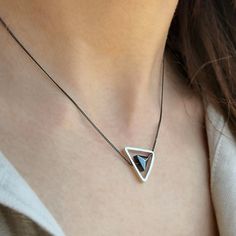 A Fidget Necklace with a triangle pendant.   A Minimalist Necklace handmade with  ✔️  Sterling Silver 925 & Hematite Gemstone ✔️   The dainty triangle hematite gemstone is carefully placed inside a silver triangle pendant.    This minimalist necklace is your perfect choice for a stylish look!     >>IS IT A GIFT? This spinner necklace comes in a beautiful artiby gift box. If you wish to send a personal message, please make a comment at the checkout process! >>SIZE  Silver triangle pendant: 0,55 i Sterling Silver Pyramid Jewelry For Gifts, Pyramid-shaped Sterling Silver Jewelry Gifts, Sterling Silver Pyramid Jewelry As Gift, Silver Triangle Jewelry For Gifts, Minimalist Triangle Jewelry For Gifts, Minimalist Triangle-shaped Jewelry For Gifts, Silver Triangle Jewelry Gift, Silver Triangle Jewelry For Gift, Silver Triangle Necklace For Gift