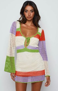 a woman is wearing a colorful crochet dress