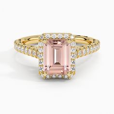 an engagement ring with a pink tourmaline surrounded by white and yellow gold diamonds