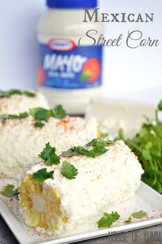 mexican sweet corn on a plate with cilantro and parsley next to it