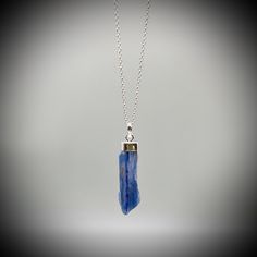 Blue Kyanite Crystal Point  and Sterling Silver Pendant on your choice of with a  16 or 18 inch sterling silver belcher chain. This is a beautiful Kyanite crystal blade, approximately 3.5cm x 1cm Our jewellery always comes beautifully gift boxed and bagged with a crystal meaning card.  BLUE KYANITE BENEFITS Aids with healing of the throat Strengthens the voice and gives confidence Creates Soothing and harmonic energy Encourages self-expression and communication All of our crystal are ethically sourced and are treated with love, care and respect. Blue Kyanite Necklace For Gift, Blue Kyanite Gemstone Necklace, Blue Nickel-free Crystal Necklace As Gift, Handmade Sapphire Blue Necklace, Blue Gemstone Crystal Necklace As A Gift, Blue Spiritual Sterling Silver Necklaces, Kyanite Necklace With Natural Stones For Gifts, Sapphire Colored Kyanite Jewelry As A Gift, Blue Spiritual Crystal Birthstone Necklace