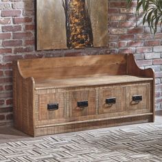 a wooden bench with four drawers in front of a brick wall and potted plant