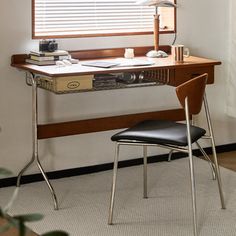 a desk with a chair and lamp in front of it