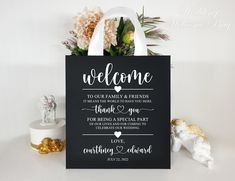 a welcome sign with flowers on the table