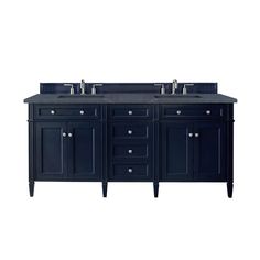 a double sink vanity with two mirrors on it's sides and dark blue cabinetry