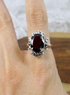 "Natural Garnet Gemstone Ring Vampire Design#84 MADE TO ORDER Inspired by Gothic & Renaissance era jewelry, I now offer this lovely Antique styles ring in sterling silver. This gorgeous ring is set with a VS to VVS genuine natural merlot-red garnet gemstone. The oval faceted cut 6.5ct to 7ct ct oval gem is 14mm (9/16th of an inch) Long by 10mm Wide (3/8th\"). The ring sits 7mm off the finger. The inside of the band is marked 925 for sterling. Notice the intricate leaf design of the filigree Vampire Design, Vampire Wedding, Antique Style Rings, Sterling Silver Garnet Ring, Gothic Ring, Garnet Gem, Gorgeous Ring, Gothic Rings, Garnet Ring