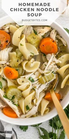 a white bowl filled with chicken noodle soup