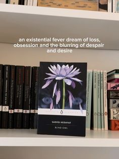 there is a book on top of the bookshelf with an image of a flower