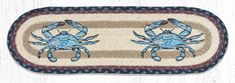 two blue crabs sitting on top of a rug