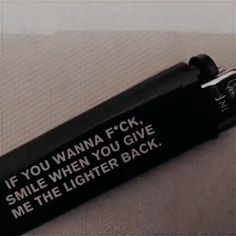 a black key chain that says if you wanna f k smile when you give me the lighter back