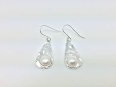 Hi everyone, just wanted to let you know we are open and shipping daily. Beautifully crafted handmade pearl and sterling silver dangle earrings. Features perfectly matched hand picked South Sea Pearls in a stunning silver setting so unique you will not go unnoticed. This line of pearl jewelry makes excellent brides made gifts and has been a top seller in our San Francisco jewelry store for years. Minimalist Sterling Silver Drop Pearl Earrings, Silver Pear-shaped Sterling Silver Pearl Earrings, Hypoallergenic Sterling Silver Pearl Drop Earrings, Hypoallergenic Sterling Silver Drop Pearl Earrings, Minimalist Silver Pearl Drop Earrings, Pear-shaped Sterling Silver Jewelry For Pierced, Sterling Silver Pear Shaped Pearl Earrings, Pierced Teardrop Pearl Earrings In Sterling Silver, Nickel-free White Gold Sterling Silver Pearl Earrings