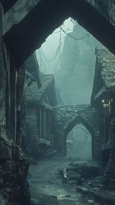 an old alley way with stone buildings and cobblestone walkways in the fog