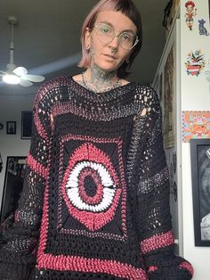 A crochet eye sweater. Made with sparkling red yarrnmixed with black. This has some long sleeves Black Oversized Bohemian Sweater, Oversized Black Bohemian Sweater, Bohemian Oversized Black Sweater, Long Sleeve Open Knit Sweater For Festival, Winter Black Crochet Top, Black Bohemian Sweater With Crochet Details, Black Bohemian Crochet Sweater, Black Crochet Top For Winter, Black Crochet Knit Sweater