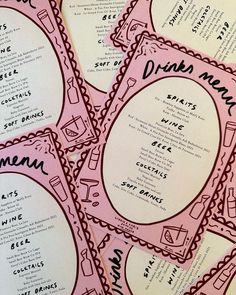 the menus are pink and have black writing on them with scalloped edges