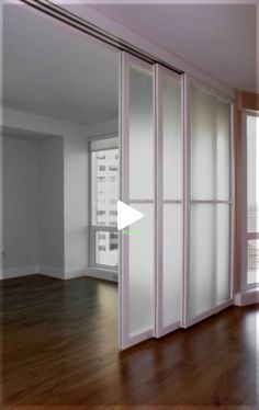 an empty room with sliding glass doors and hardwood floors