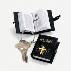 an open bible and keychain with a book on it