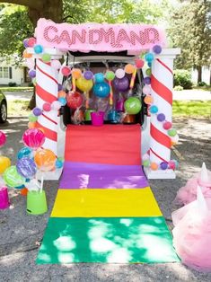 an ice cream stand decorated with candy and balloons for a candy land birthday party or baby shower