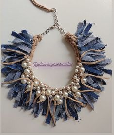 the necklace is made with denim and pearls