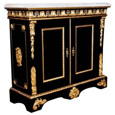 an ornate black and gold cabinet with two doors on the front, one door open