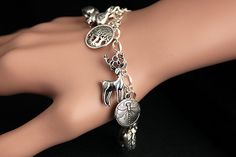 A collection of silver plated woodland themed charms have been dispersed around a shimmering silver plated bracelet chain in this handmade charm bracelet. This nature lover charm bracelet is then completed with a lobster clasp and a 1/2 inch of chain at the end for adjustable sizing. Charms in this bracelet include a rabbit charm, squirrel charm, pair of acorns charm paired with a leaf charm, a fox charm, owl charm, dragonfly charm, pine cone charm, copse of trees charm, and a deer charm. ● Sizi Whimsical Silver Charms For Gifts, Whimsical Silver Dangling Charms, Silver Charm Bracelet With Vintage Charm As A Gift, Silver Vintage Charm Bracelet Gift, Whimsical Hypoallergenic Silver Jewelry, Whimsical Nickel-free Charm Bracelet Gift, Whimsical Nickel Free Charm Bracelet Gift, Bohemian Silver Dangling Charms, Bohemian Silver Charms With Dangling Details