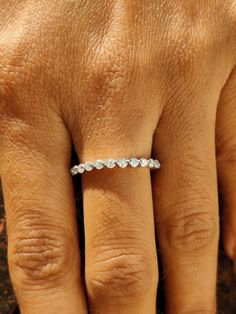 a woman's hand with a diamond ring on it