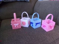 three small baskets sitting on top of a couch