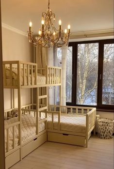 a room with bunk beds and a chandelier