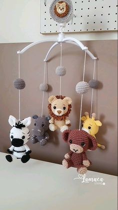 three crocheted stuffed animals hanging on a wall