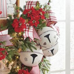 a decorated christmas tree with bells and poinsettis