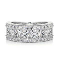 a wedding band with three rows of round cut diamonds on the sides and two rows of round