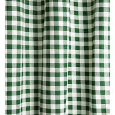 a green and white checkered curtain hanging on a window