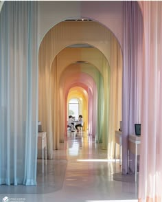 the hallway is lined with colorful curtains and drapes that are hanging from the ceiling