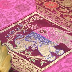 an elephant on a pink and gold cloth