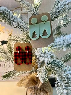 Adorable Christmas tree cutout earrings. Perfect for any Holiday occasion!  Two colors to choose from: sage green or buffalo plaid.  Earrings measure: 2 inches long 1 inch wide All earrings are made of acrylic with hypoallergenic, nickel-free posts. If you have a sensitivity to a certain metal, please let us know. We will happily switch out the hardware.  Also, if you have any questions or are looking for a specific design, let us know! We would love to help you out! We recommend taking earrings off before showering, swimming, or sleeping.  Slight variation may occur compared to the pictures as they are handmade items. Please message us with any questions prior to ordering. We are happy to answer! If you love these, check out our other earrings! Tree Cutout, Plaid Earrings, Handmade Clay Jewelry, Play Clay, Holiday Earrings, Tree Earrings, Christmas Tree Earrings, Earrings Christmas, Holiday Earring