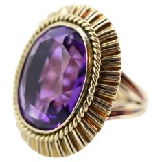 Vintage from the 1920s Size: 6.5 US Materials: Stone Gemstone: Amethyst Gem color: Purple Band Color: Purple Style: Art deco Magnificent Vintage Cocktail ring from the 20s, maybe earlier. Beautiful treasure. 14k Yellow Gold ring. Hand Made. Total weight 13.4 grams. Huge Oval cut Amethyst. Measured 20mm by 15mm by 10mm. Total estimated CTW is 16. Amethyst has shows some wear. Not seen when worn. All of our pieces are priced below appraisal and fair, but if you love a piece and would love to make an offer, don't hesitate. We at VoxMarket would appreciate and love your business. Wide Wedding Bands, 14k Gold Wedding Band, Amethyst Set, Purple Style, Vintage Cocktail Ring, Green Amethyst Ring, Style Art Deco, Gold Cocktail Ring, Ring Hand