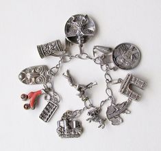 "A wonderful sterling silver bracelet with some stamped and some not stamped sterling silver and other metal charms. Big and small charms, chunky and changly! Bracelet is 6.5 inches long. Here are the charms: 1. Salzberg castle: stamped 800, .75 inches wide 2. Mexican trumpeter: no stamp, 1 inch tall (silver) 3. Ram: stamped Sterling, .50 inches 4. Deutschland : Stamped 800, 1 inch 5. Arc de triomphe: no stamp, .75 inches wide.25 inches wide (silver) 6. 1969 First Lunar LandingApollo 11: stamped Antique Silver Sterling Jewelry With Vintage Charm, Antique Silver Charms Sterling Silver Jewelry, Antique Silver Sterling Silver Charm Jewelry, Unique Nickel-free Silver Charm Bracelet, Unique Silver Nickel-free Charm Bracelet, Collectible Nickel-free Sterling Silver Charms, Antique Sterling Silver Charms, Nickel Free, Nickel-free Silver Charm Bracelet Collectible, Antique Sterling Silver Nickel-free Charms